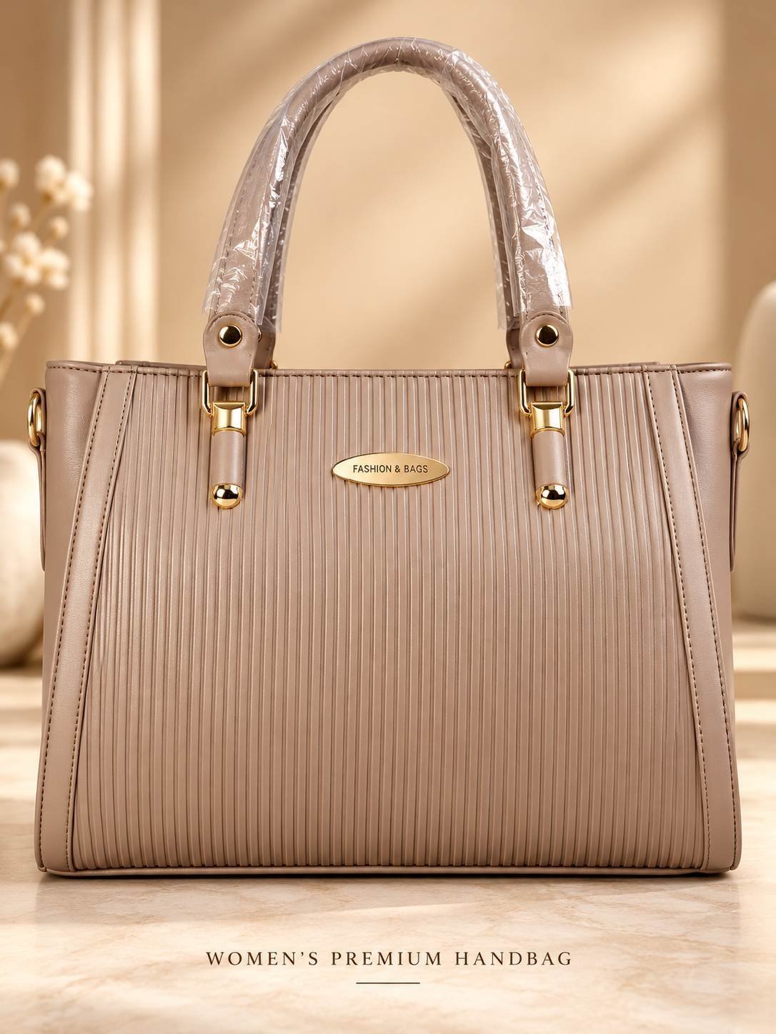 Women's taupe beige ribbed handbag with dual top handles, gold-tone fittings and an oval front nameplate