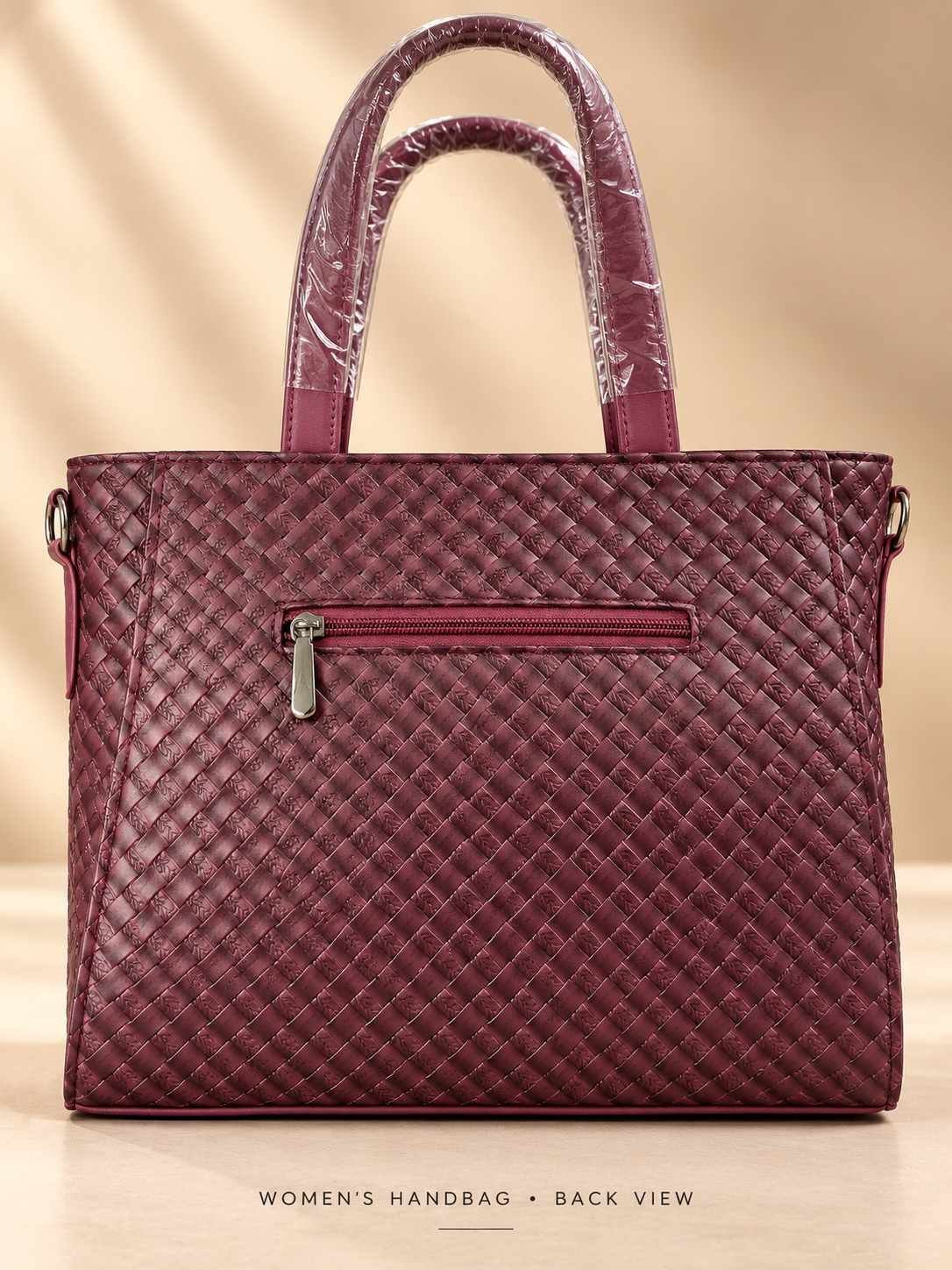 Women's burgundy woven-texture handbag with glossy finish, two top handles and square gunmetal fittings — image 2