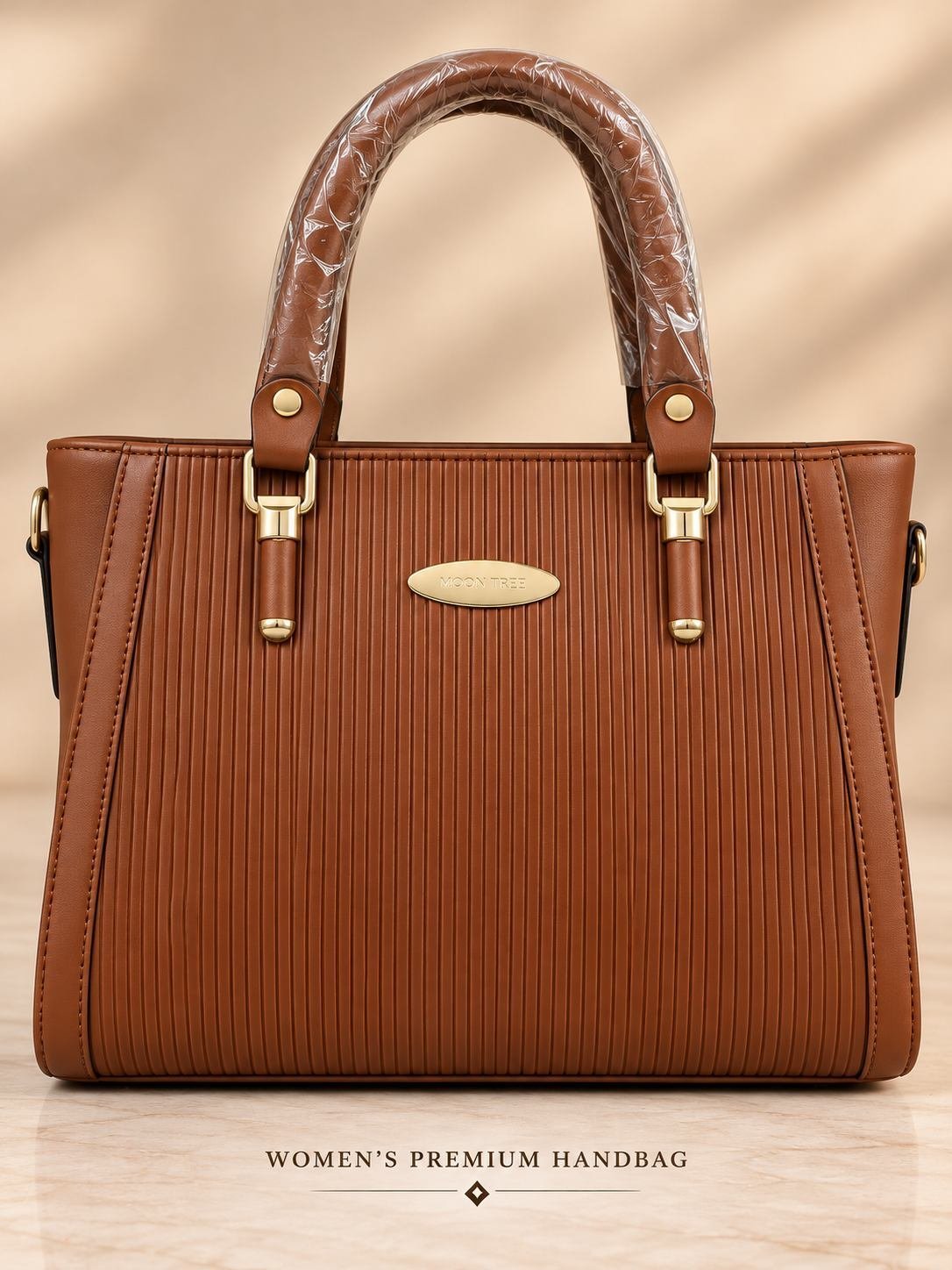 Women's brown ribbed handbag with two rounded top handles, gold-tone hardware and an oval front logo plate