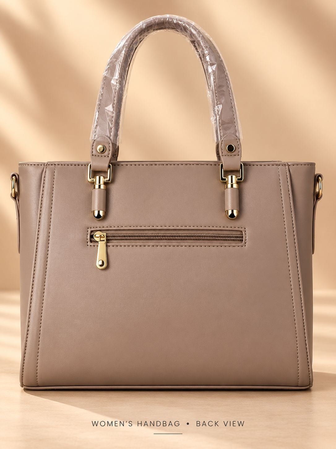 Women's taupe beige ribbed handbag with dual top handles, gold-tone fittings and an oval front nameplate — image 2