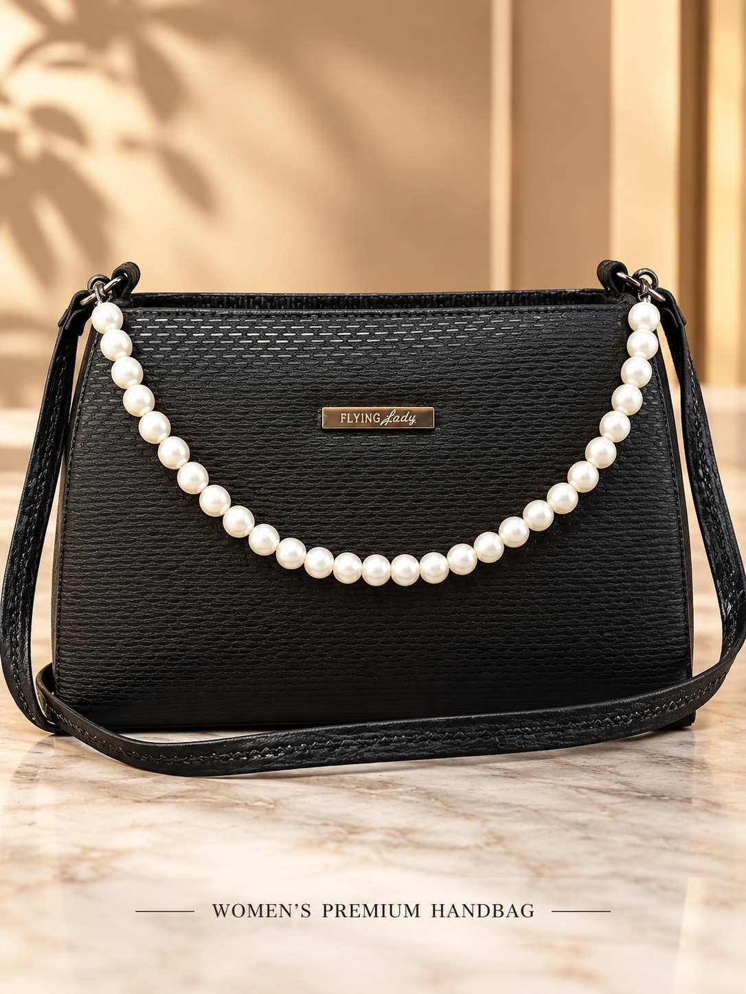 Women's black woven-texture shoulder bag with a pearl-bead top handle, metallic nameplate and long black strap