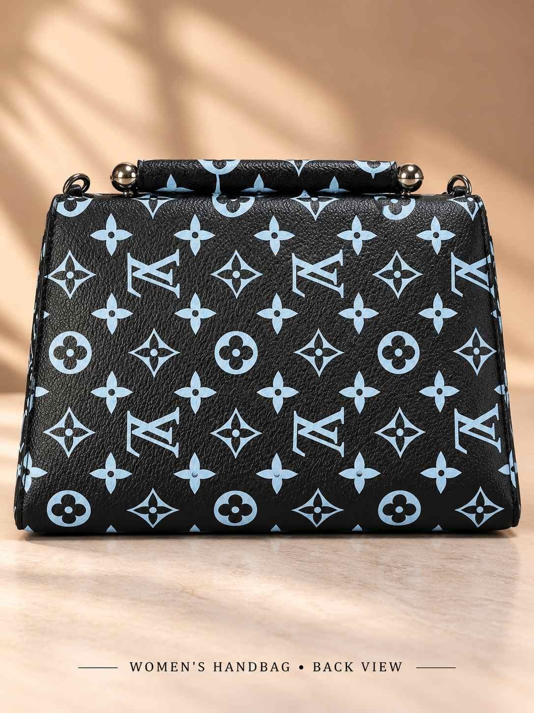 Women's black structured handbag with all-over light blue print, top bar handle with metal ball ends and metal front emblem — image 2