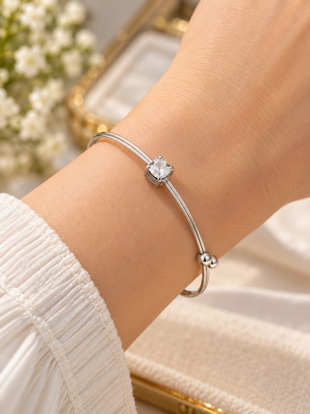 Silver-tone double line open cuff bracelet for women with a square clear crystal in a four-prong setting and ball ends