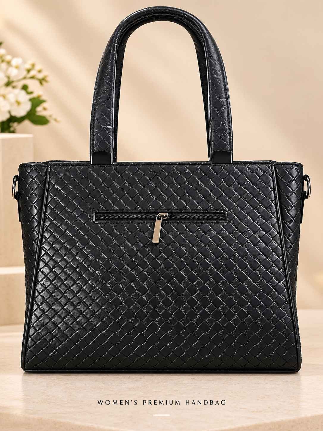 Women's black woven-texture handbag with glossy finish, two rounded top handles and square gunmetal fittings — image 2