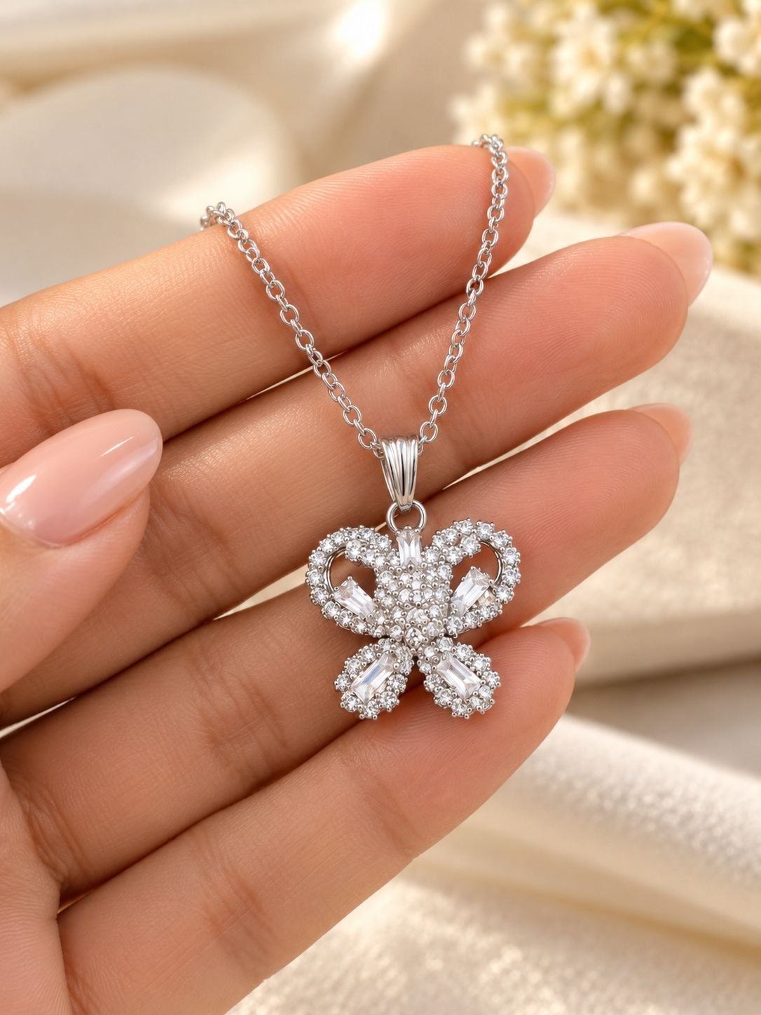 Silver-tone butterfly pendant necklace for women with clear stones and baguette crystals on a fine chain, worn on the neck — image 3