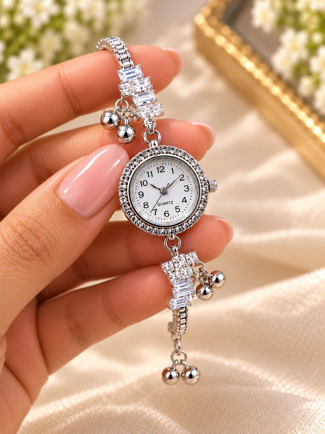 Silver-tone bracelet watch for women with white numbered dial, stone-set bezel, stone-set strap and dangling ball charms — image 3